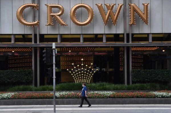 A person walks past signage at the Crown Casino in Melbourne, Australia, on March 22, 2021. (William West/AFP via Getty Images)