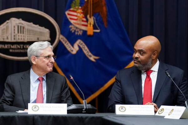 Attorney General Merrick Garland (left) looks at federal prosecutor Kevin Chambers (right) after appointing him to be the Justice Department's chief pandemic fraud prosecutor during a meeting of the COVID-19 Fraud Enforcement Task Force at the Justice Department in Washington on March 10, 2022. The U.S. Secret Service recovered $286 million in fraudulently obtained pandemic funds to the Small Business Administration on Aug. 26, 2022. (Kevin Lamarque/Pool Photo via AP, File)