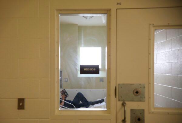 An inmate reads a book while in the infirmary at Las Colinas Women's Detention Facility in Santee, Calif., on April 22, 2020. (SANDY HUFFAKER/AFP via Getty Images)