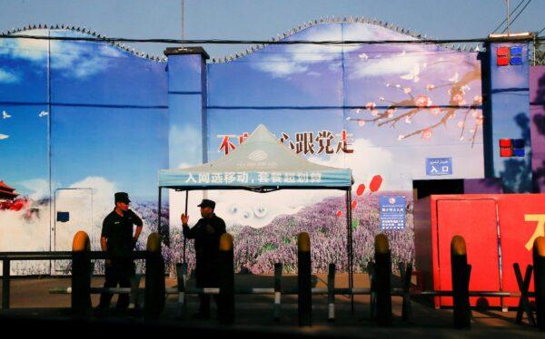 Security guards stand at the gates of what is officially known as a vocational skills education center in Huocheng County in Xinjiang Uighur Autonomous Region, China on Sept. 3, 2018. (Thomas Peter/Reuters)