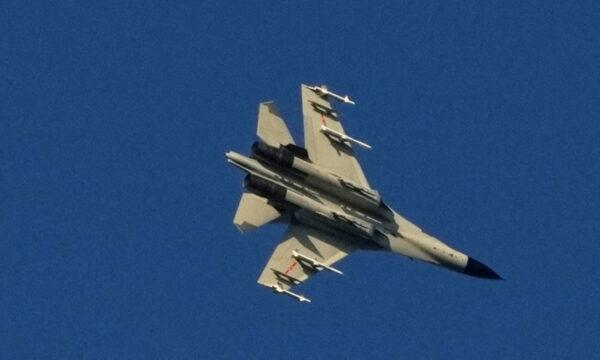 A Chinese aircraft flies over the 68-nautical-mile scenic spot, one of mainland China's closest points to the island of Taiwan, in Pingtan island, Fujian Province, China, on Aug. 5, 2022. (Aly Song/Reuters)