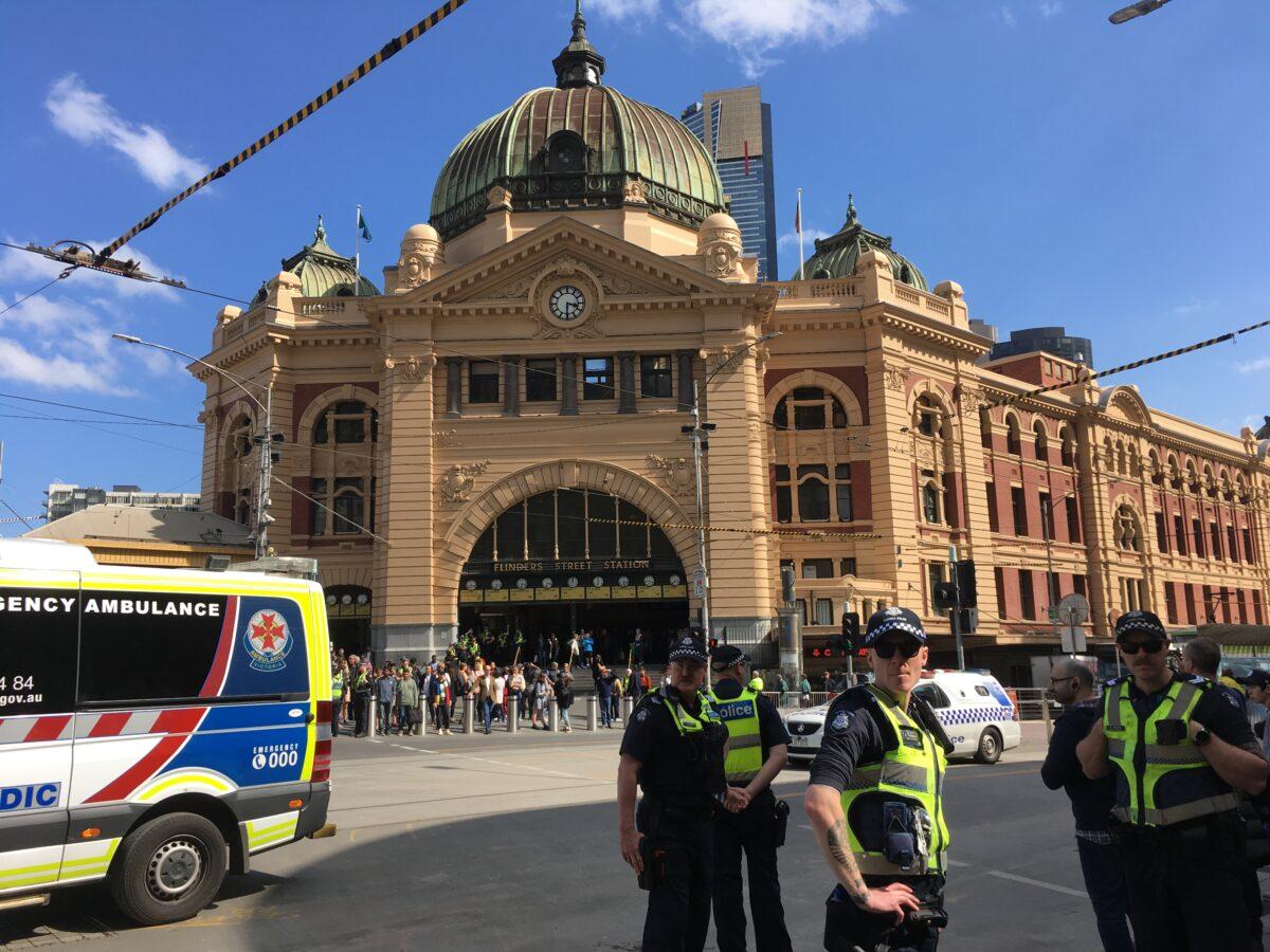 Police gather near Flinders Station in Melbourne, Australia. (Melanie Sun/The Epoch Times)