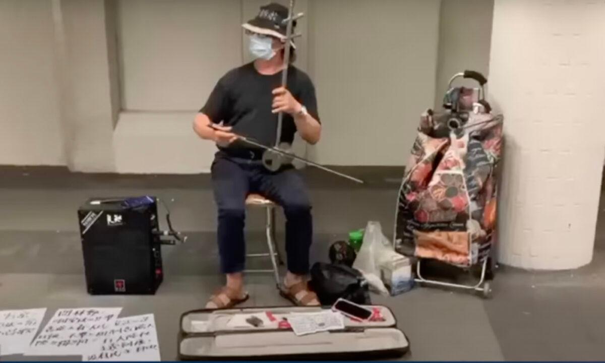 Li Jiexin was charged for playing "Glory to Hong Kong" on the erhu at Tung Chung Bus Terminal on April 29, 2022. (HK Situation Report/Screenshot via The Epoch Times)