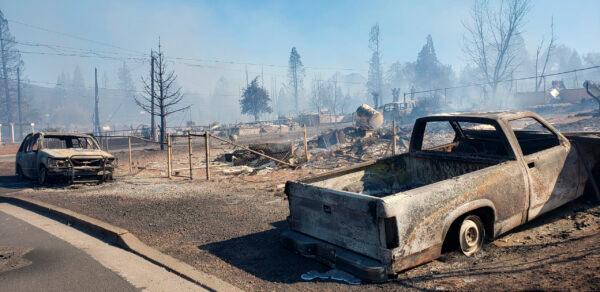 A neighborhood smolders after being destroyed by the Mill Fire in Weed, Calif., on Sept. 2, 2022. (Hung T. Vu/The Record Searchlight via AP)