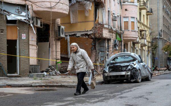 An elderly woman walks past a building partially destroyed by a missile strike in the center of Kharkiv, Ukraine, on Sept. 13, 2022. (Sergy Bobok/AFP via Getty Images)