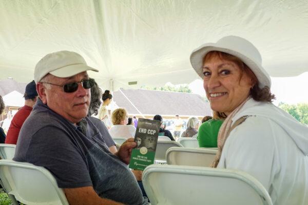 Bob and Dee Steeger signed the petition to end the Chinese Communist Party at the Moon Festival in Deerpark, N.Y., on Sept. 17, 2022. (Cara Ding/The Epoch Times)