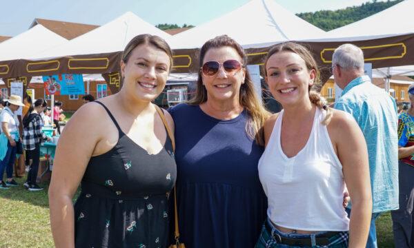 Sam Kressevich (L), Lori Kressevich, and Alex Kressevich (R) enjoy the Moon Festival in Deerpark, N.Y., on Sept. 17, 2022. (Cara Ding/The Epoch Times)