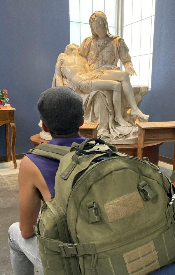 A homeless man enjoys a quiet moment in a chapel inside The Zone in downtown Phoenix, on Sept. 18. (Allan Stein/The Epoch Times)