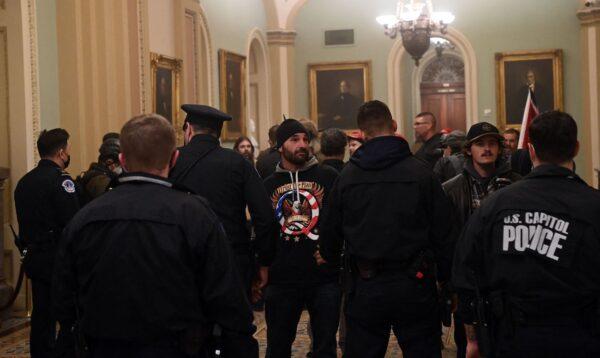 Douglas Jensen stands with other protesters, facing Capitol police officers as they try to stop people from entering the Capitol building in Washington, on Jan. 6, 2021. (Saul Loeb/AFP via Getty Images)