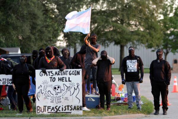 Antifa members display their own signs at the site of a protest against a drag bingo event at a church in Katy, Texas, on Sept. 24, 2022. (Bobby Sanchez for The Epoch Times)