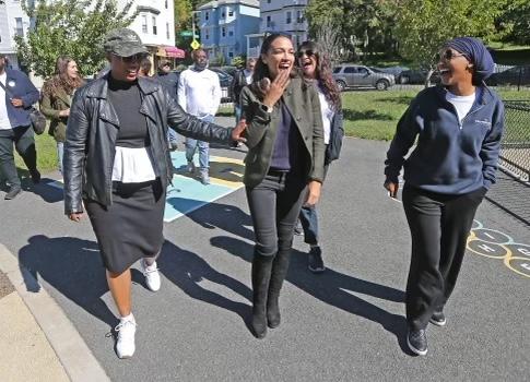 Members of The Squad walk down a street in Somerville, Mass., on Sept. 24. (Supplied)