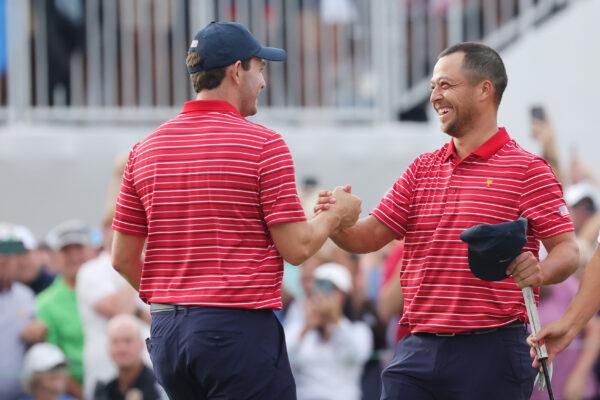 Patrick Cantlay (L) of the United States Team congratulates teammate Xander Schauffele (R) after his 1 Up win against Corey Conners of the International Team on Sunday singles matches on day four of the 2022 Presidents Cup at Quail Hollow Country Club in Charlotte, N.C., on Sept. 25, 2022. (Stacy Revere/Getty Images)
