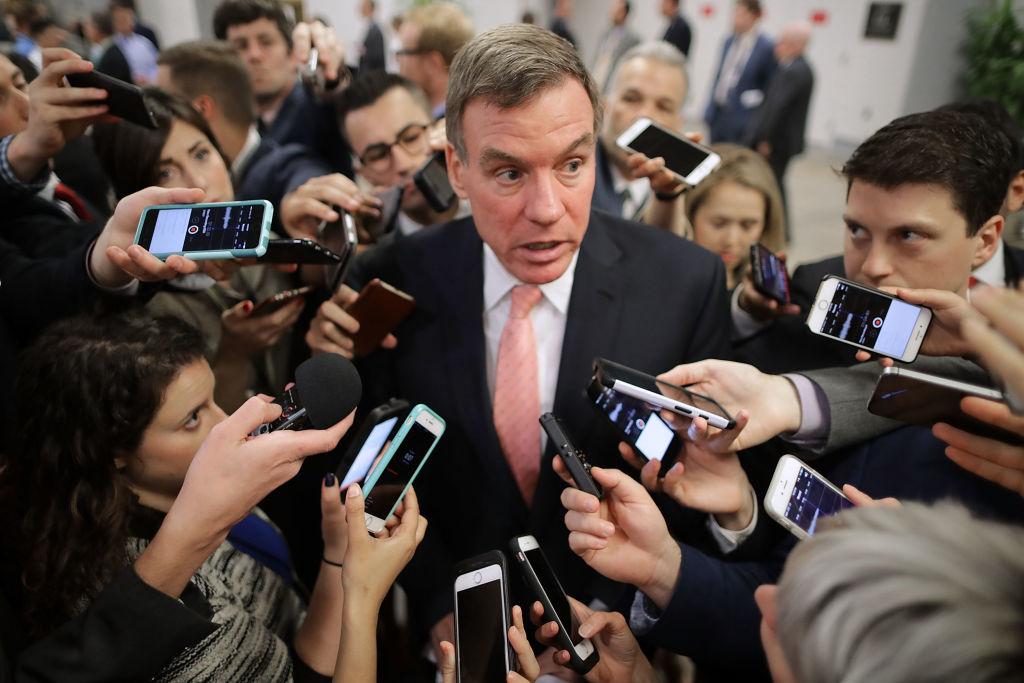 Reporters surround Senate Intelligence Committee ranking member Sen. Mark Warner (D-Va.) as he heads for his party's weekly policy luncheon at the U.S. (Chip Somodevilla/Getty Images)