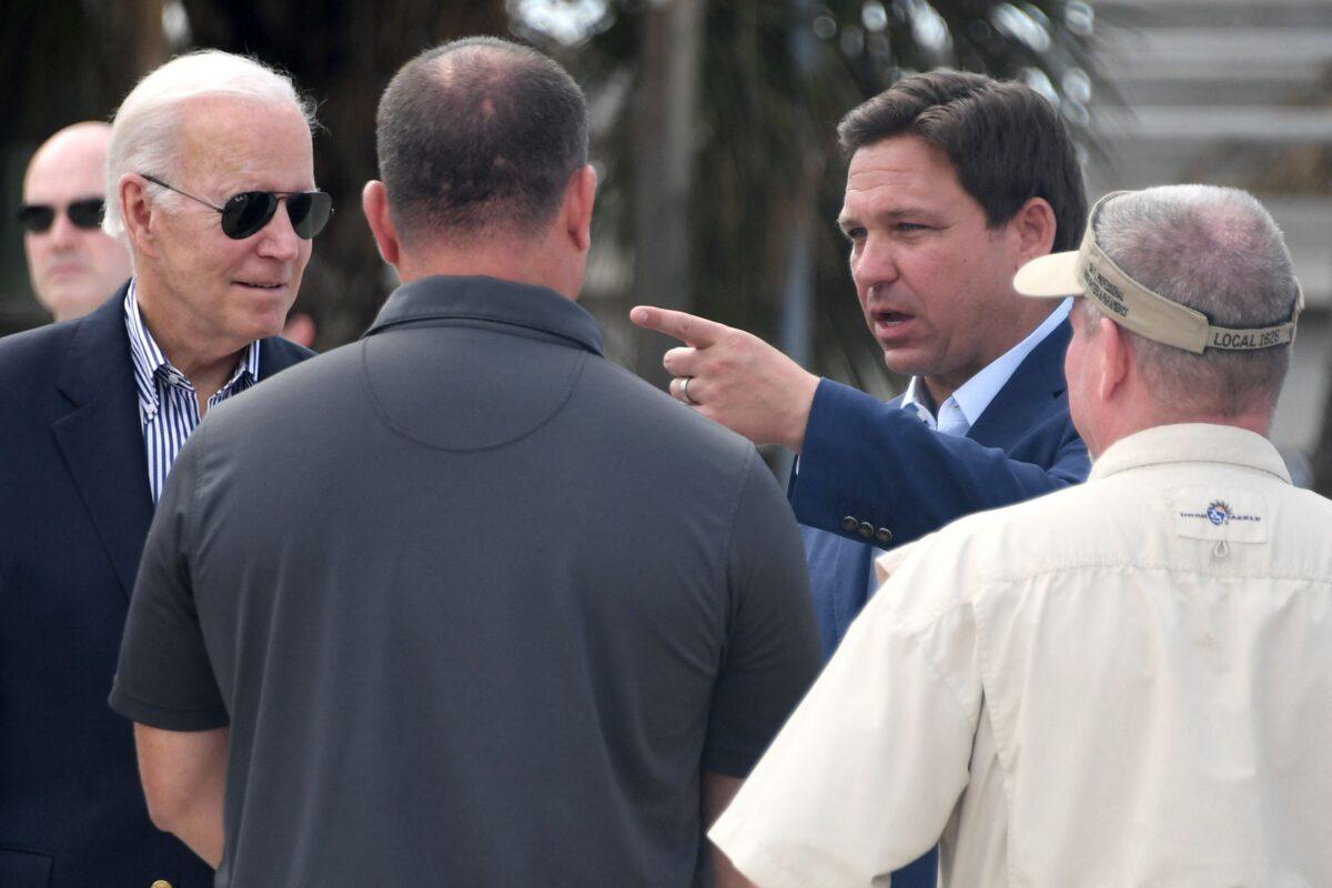 President Joe Biden and Florida Governor Ron DeSantis meet with local residents impacted by Hurricane Ian at Fishermans Pass in Fort Myers, Fla., on Oct. 5, 2022. (Olivier Douliery/AFP via Getty Images)