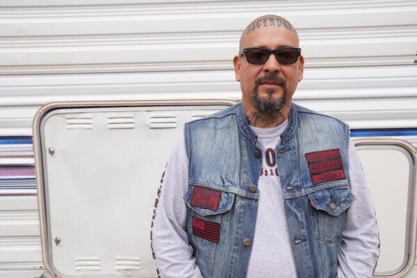 Eddie "Smiley" Hernandez of Phoenix joined the Ascendants Motorcycle Club three years ago after being homeless for nearly a decade. Below, he displays his tattooed scalp during a club gathering in Jerome, Ariz., on Oct. 15, 2022. (Allan Stein/The Epoch Times)