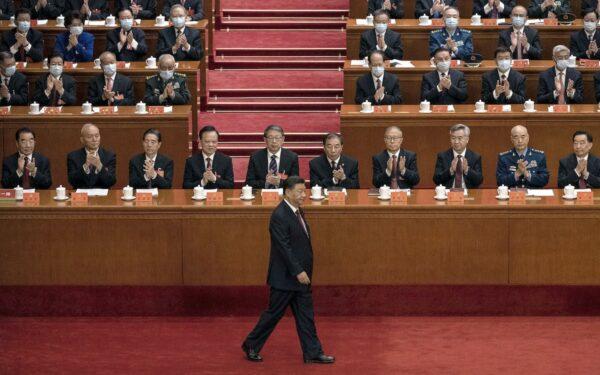 Chinese leader Xi Jinping (C) is applauded by senior members of the government and delegates as he walks to the podium to make a speech during the opening ceremony of the 20th National Congress in Beijing, China, on Oct. 16, 2022. Xi is expected to secure a third term in power. (Kevin Frayer/Getty Images)