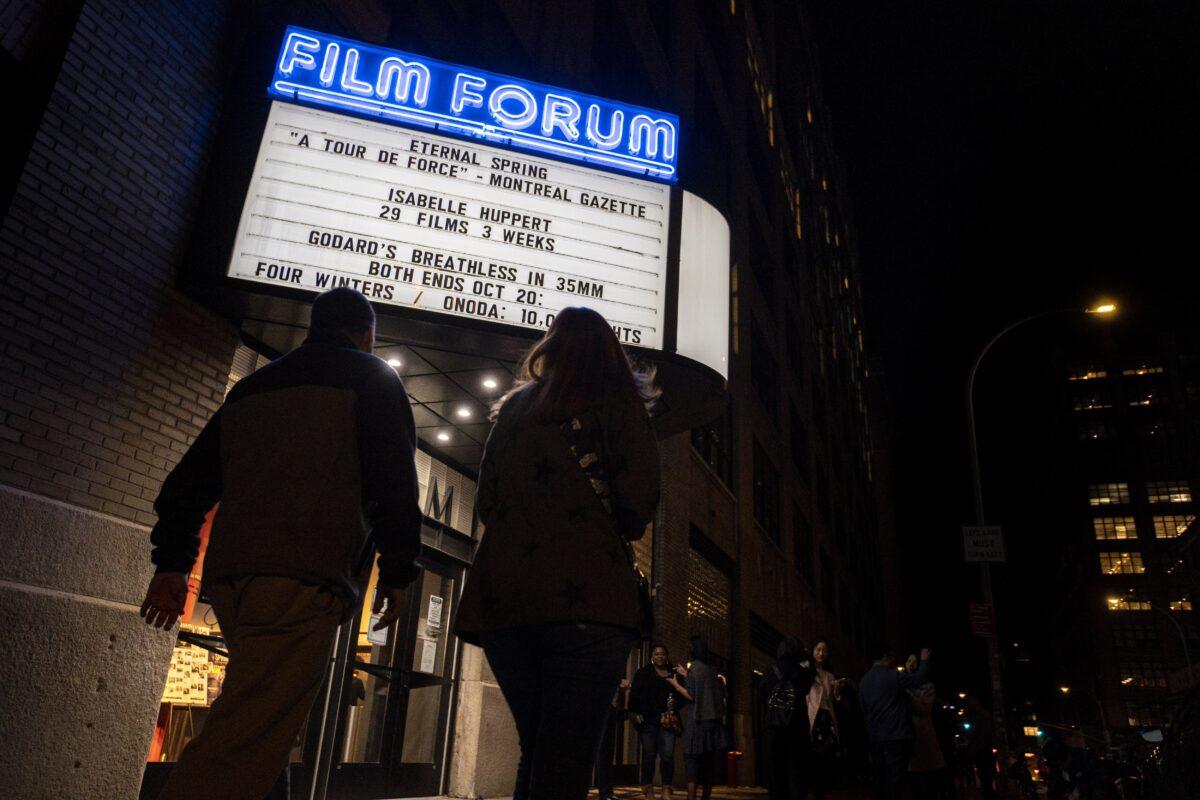 People walk past the Film Forum ahead of a film screening of the documentary "Eternal Spring" at in Manhattan, New York City, on Oct. 14, 2022. (Chung I Ho/The Epoch Times)