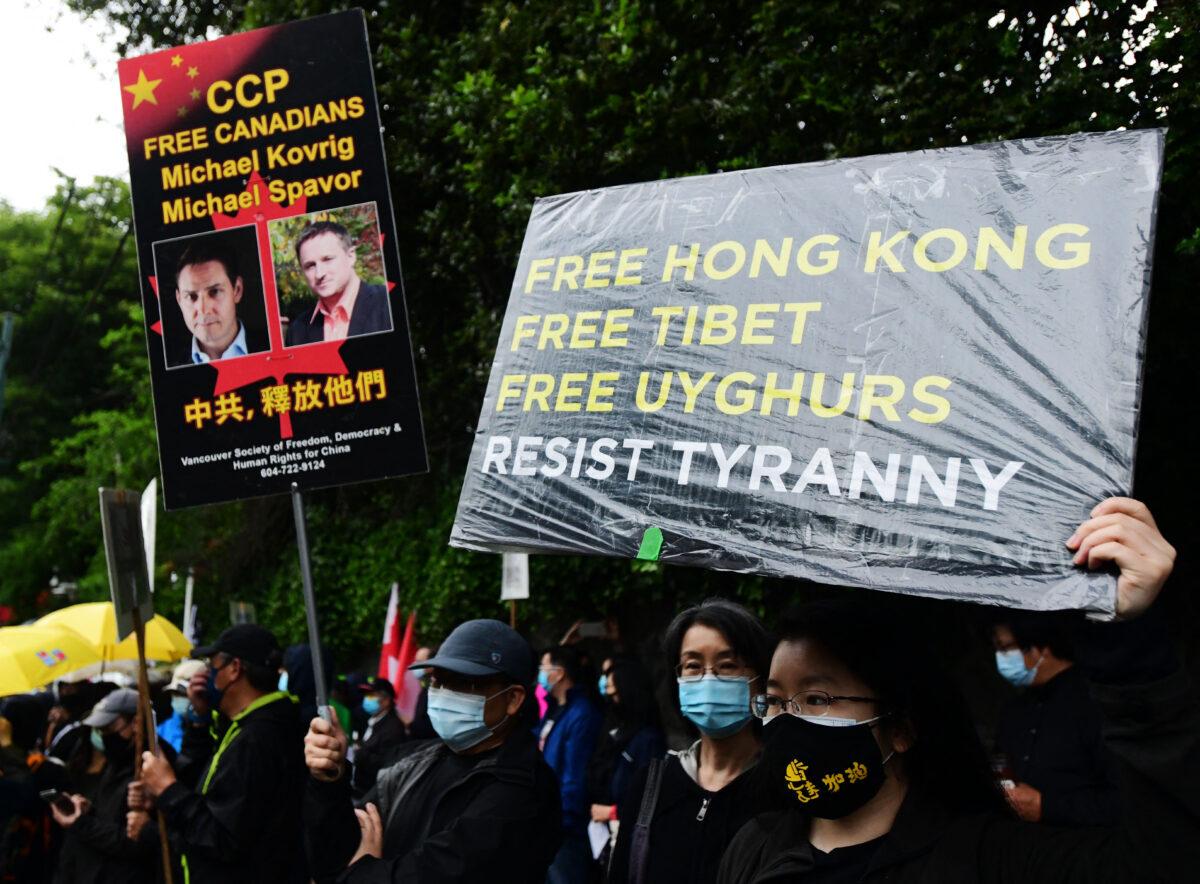 People attend a vigil commemorating the 32nd anniversary of the 1989 Tiananmen Square pro-democracy protests and clampdown outside the Chinese Consulate in Vancouver on June 4, 2021. (Don MacKinnon/AFP)