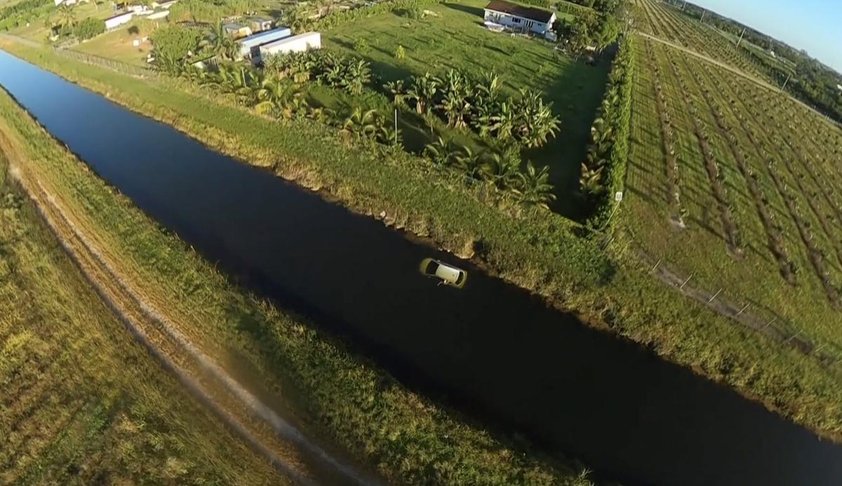 Footage from Piquet's glider-cam shows a car and a woman stranded in a canal in south Miami. (Courtesy of <a href="https://www.instagram.com/cristianopiquet/">Cristiano Piquet</a>)