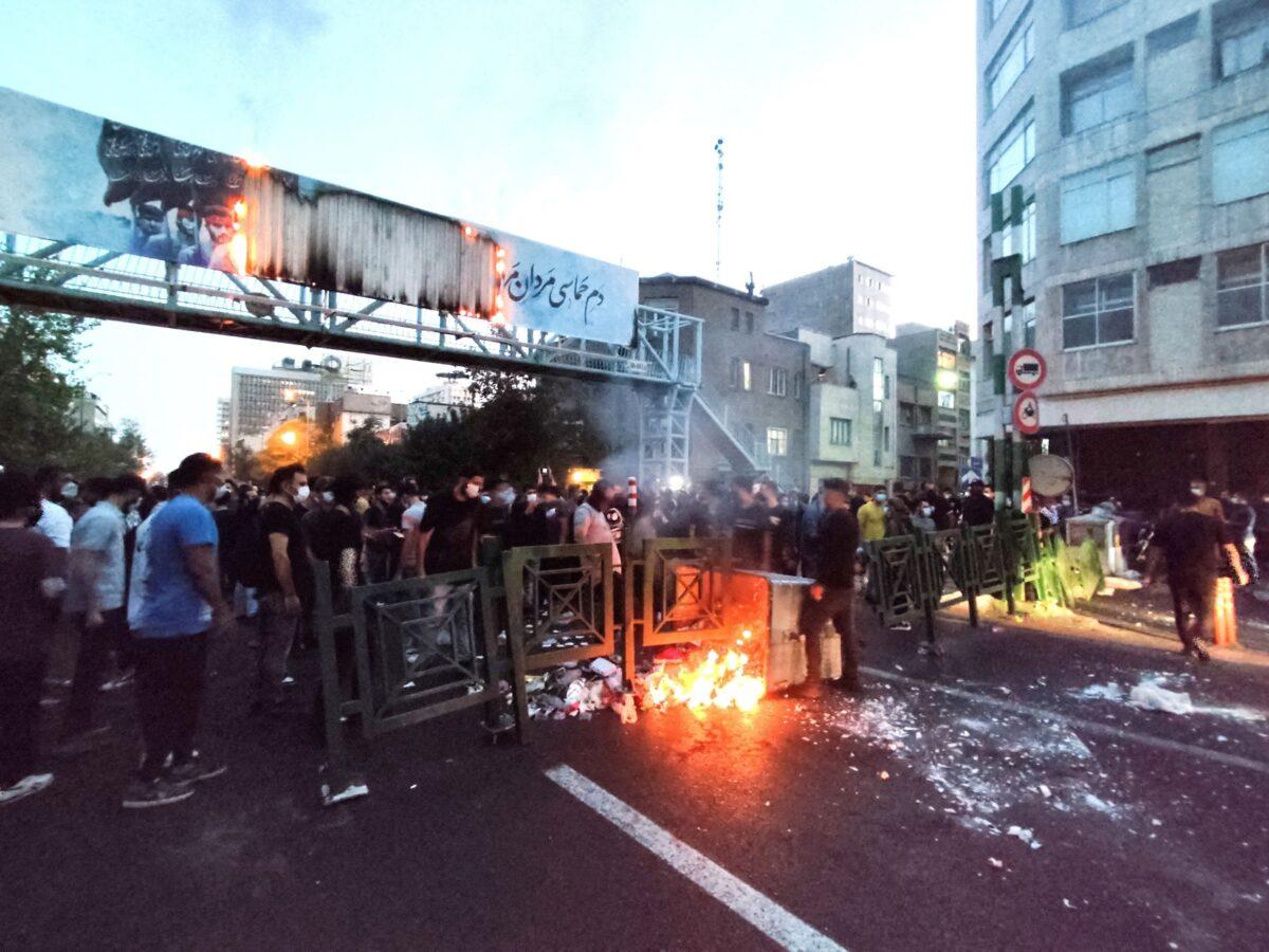 People light a fire during a protest over the death of Mahsa Amini, a woman who died after being arrested by the Islamic republic's "morality police" in Tehran, Iran, on Sept. 21, 2022. (West Asia News Agency (WANA) via Reuters)