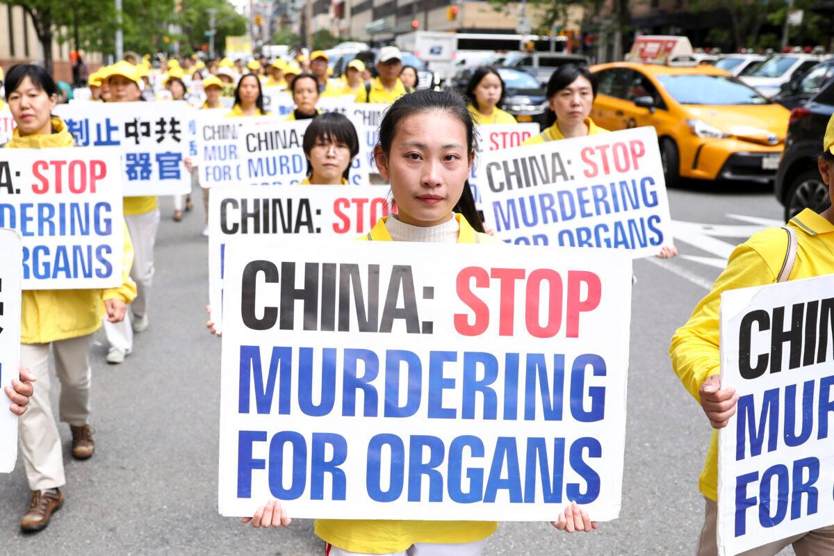 Falun Dafa practitioners hold placards in a parade to raise awareness about the CCP's persecution of the faith in China, in Manhattan, New York, on May 16, 2019. (Samira Bouaou/The Epoch Times)
