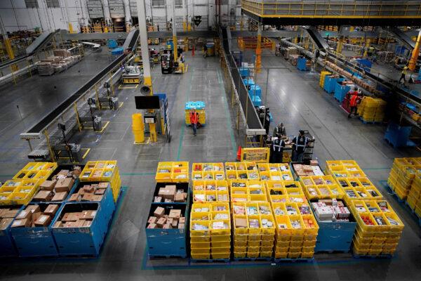 Workers select and pack items during Cyber Monday at the Amazon fulfilment center in Robbinsville Township, N.J., on Nov. 28, 2022. (Eduardo Munoz/Reuters)