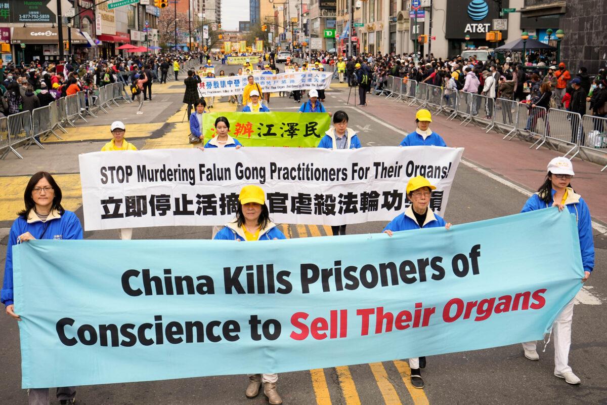 Falun Gong practitioners take part in a march to raise awareness about the Chinese regime's brutal persecution of the spiritual practice, including forced organ harvesting, in New York on May 13, 2022. (Larry Dye/The Epoch Times)