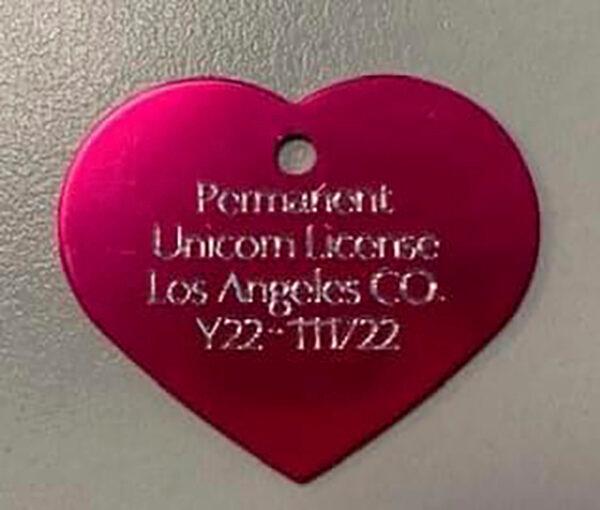 This image shows a created permanent Unicorn License, a heart-shaped tag, after a young girl requested permission to have a unicorn in her backyard if she could find one. (Los Angeles County Animal Care and Control via AP)
