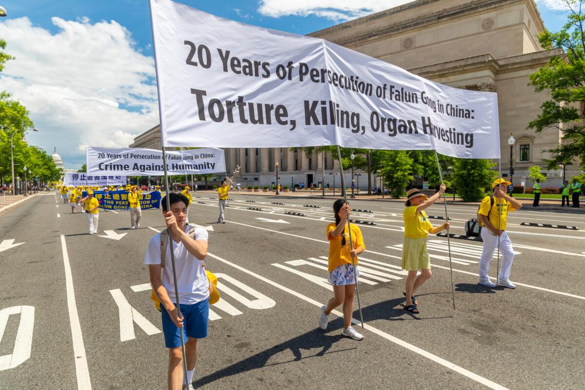 Falun Gong practitioners take part in a parade commemorating the 20th anniversary of the persecution of Falun Gong in China, in Washington on July 18, 2019. (Mark Zou/The Epoch Times)
