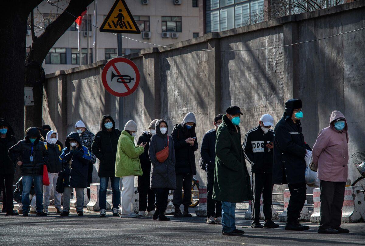 People line up outside a fever clinic at a hospital in the morning in Beijing on Dec. 11, 2022. (Kevin Frayer/Getty Images)