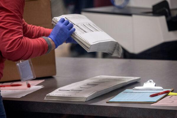An election worker sorts ballots at the Maricopa County Tabulation and Election Center in Phoenix, Ariz., on Nov. 9, 2022. (John Moore/Getty Images)