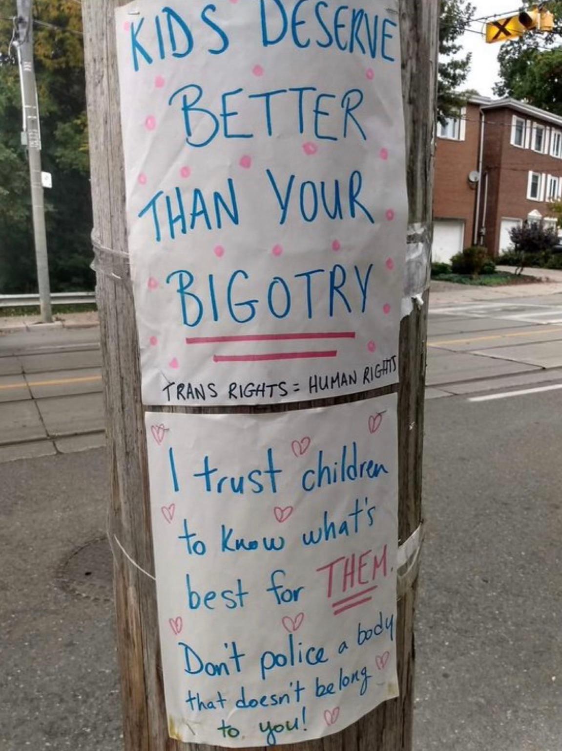 A sign is placed by pro-transgender supporters to protest Canadian activist Chris Elton in Toronto in 2022. (Courtesy of Billboard Chris)