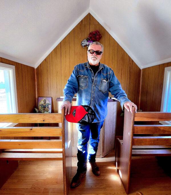 Mike Sponsel, 69, of Denver, Col., stands at the altar inside Loren Pratt's Little Chapel in Yuma, Ariz., on Dec. 8, 2022. Sponsel lost his son, Mike Jr., to a blood clot in 2021. This year, he came to say a prayer for his son and tries to stay positive going into 2023. (Allan Stein/The Epoch Times)
