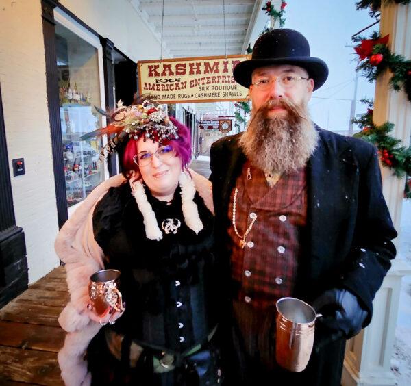 Michael Molisani and his wife, Tora Engle-Molisani stroll along the boardwalk in period costume during a snowstorm in Virginia City, Nev., on Dec. 10, 2022. (Allan Stein/The Epoch Times)