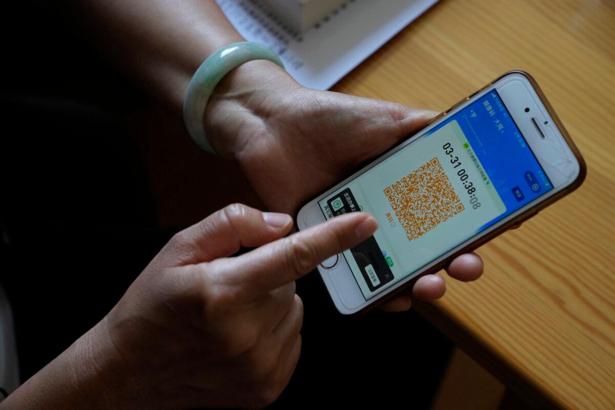 Activist Wang Yu points to a screenshot of her yellow health code in Beijing on June 30, 2022. (Ng Han Guan/AP Photo)
