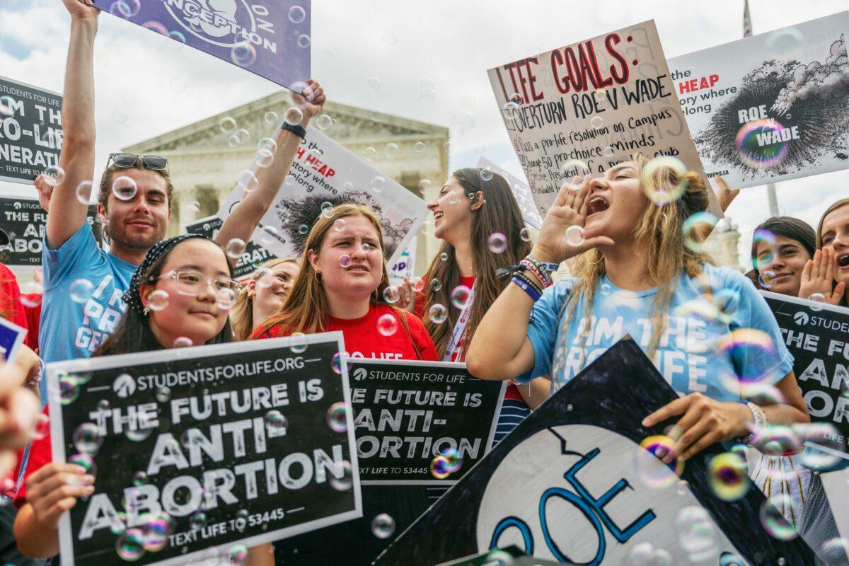 Pro-life activists celebrate outside the Supreme Court after the top court ruled to send abortion law to the states to decide, in Washington on June 24, 2022. (Brandon Bell/Getty Images)