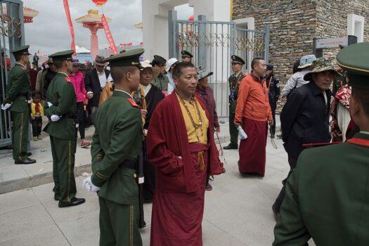 Chinese paramilitary police secure an exit as Tibetan monks leave a stadium at the end of a local government-sponsored festival in Yushu, in the northwestern Chinese province of Qinghai, on July 25, 2016. (Nicolas Asfouri/AFP via Getty Images)