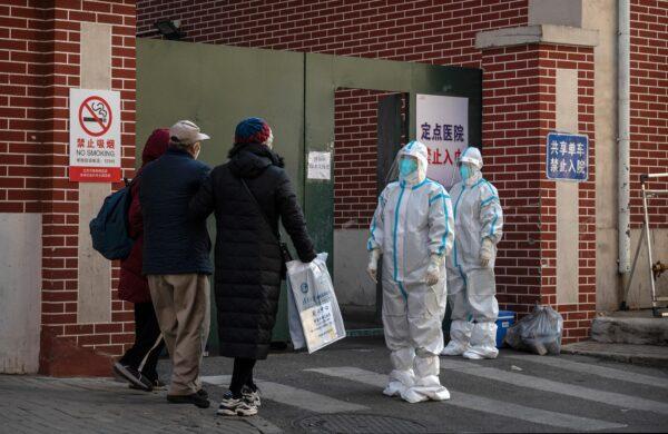 Medical staff wait to assist a patient at a fever clinic treating COVID-19 patients in Beijing on December 21, 2022. (Kevin Frayer/Getty Images)