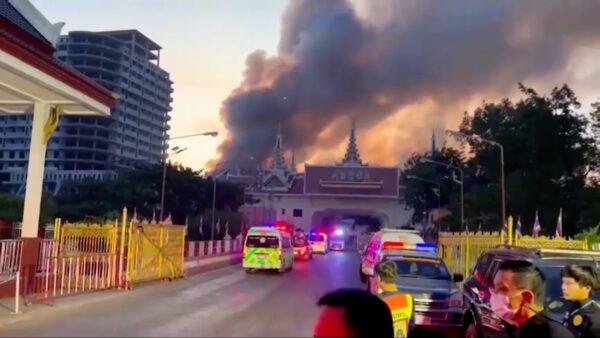 Thai ambulances rush to cross a checkpoint to reach a burning casino on the Cambodian side of the border on Dec. 29, 2022. (Reuters)