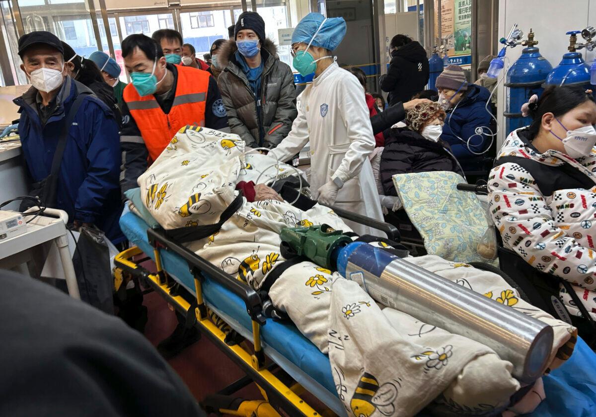 A patient on oxygen is wheeled into a busy emergency room at a hospital in Beijing on Jan. 2, 2023. (Getty Images)