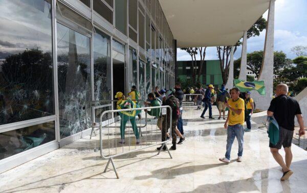 Rioters destroy a window of the the plenary of the Supreme Court in Brasilia on Jan. 8, 2023. (Ton Molina/AFP via Getty Images)