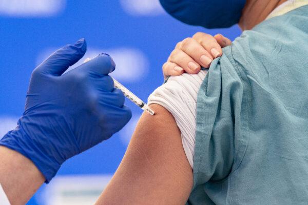 A nurse receives a COVID-19 vaccination in Orange, Calif., on Dec. 16, 2020. (John Fredricks/The Epoch Times)