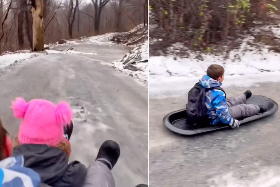 VIDEO: Determined Mom Beats Icy Winter Roads by Sledding Her Kids to School