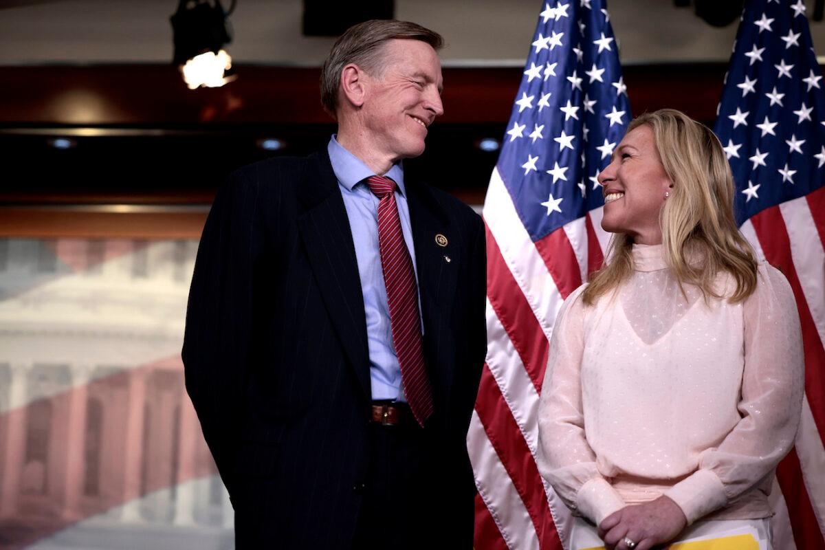 Rep. Marjorie Taylor Greene (R-Ga.) smiles at Rep. Paul Gosar (R-Ariz.) during a news conference at the U.S. Capitol Building in Washington, on Dec. 7, 2021. (Anna Moneymaker/Getty Images)