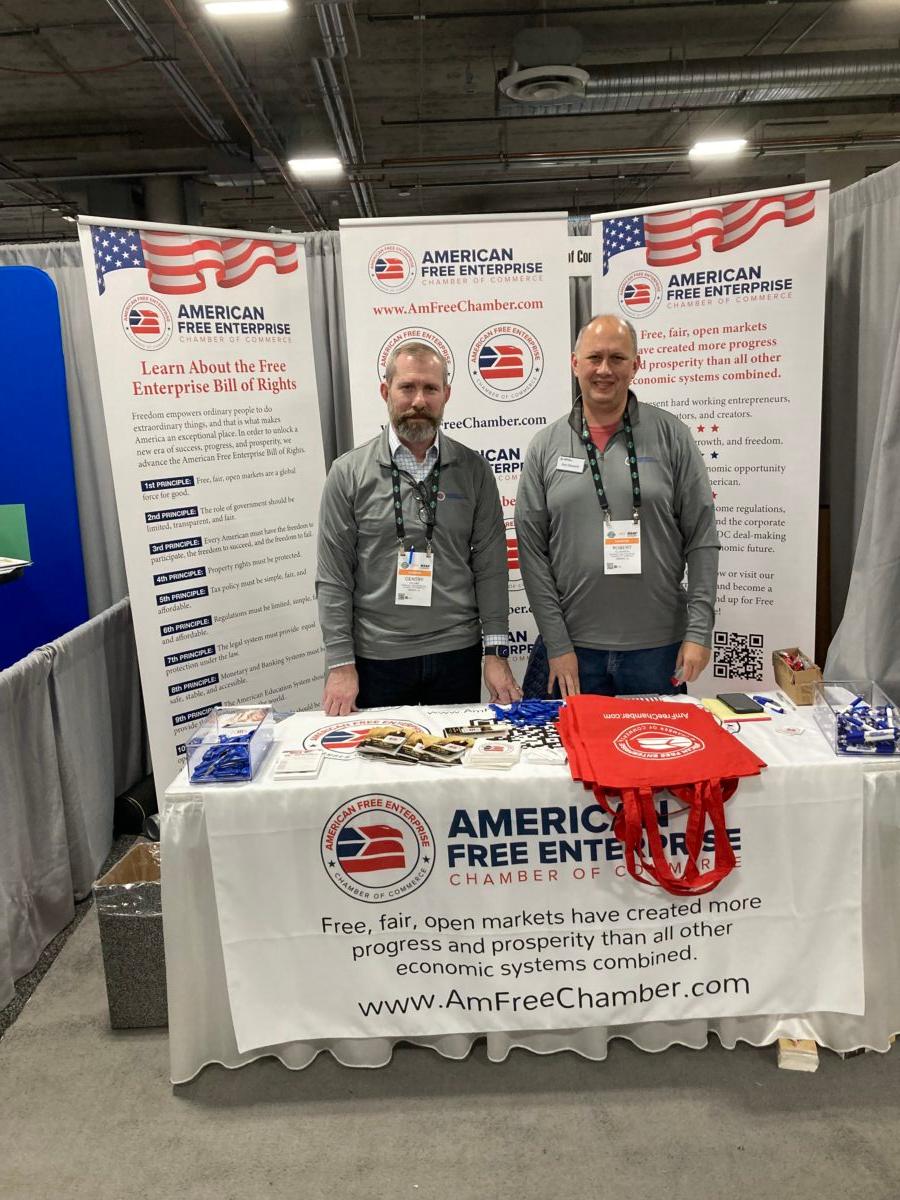 American Free Enterprise CEO Gentry Collins (L) and volunteer Robert Ellsworth man their booth at the SHOT Show in Las Vegas, offering businesses "debanked" and "deplatformed" by corporate policies alternate service providers. (John Haughey/Epoch Times)