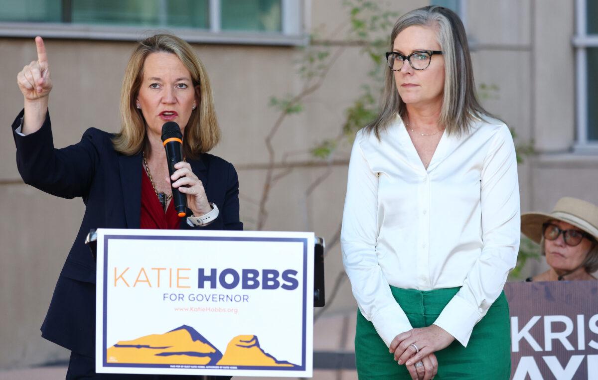 Arizona Secretary of State and Democratic gubernatorial candidate Katie Hobbs (R) looks on as Kris Mayes (L), Democratic candidate for Arizona attorney general, speaks at a press conference calling for abortion rights outside the Evo A. DeConcini U.S. Courthouse in Tucson, Arizona, on Oct. 7, 2022. (Mario Tama/Getty Images)