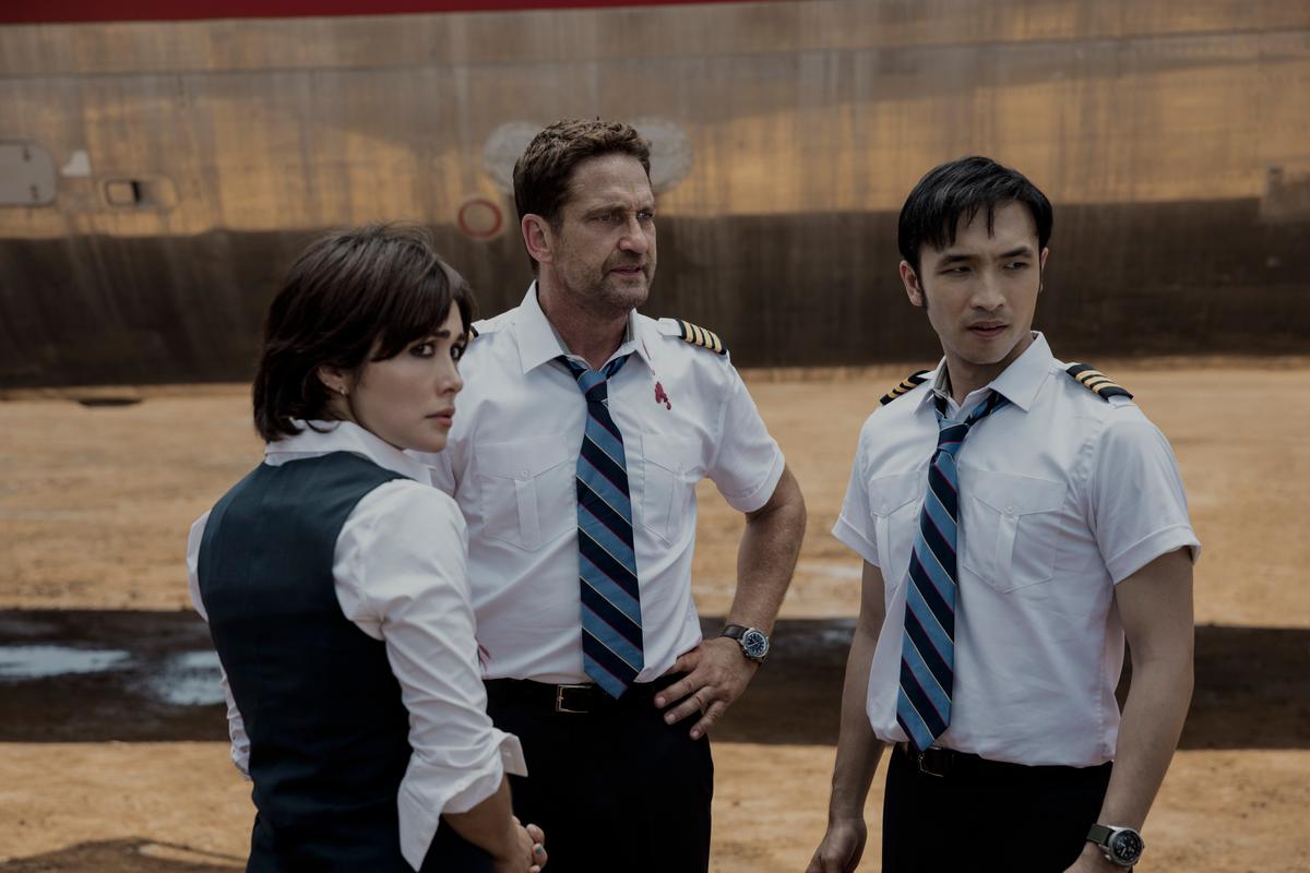 (L–R) Bonnie (Daniella Pineda), Captain Brodie Torrance (Gerard Butler) and Dele (Yoson An), in a scene from "Plane." (Kenneth Rexach/Lionsgate)