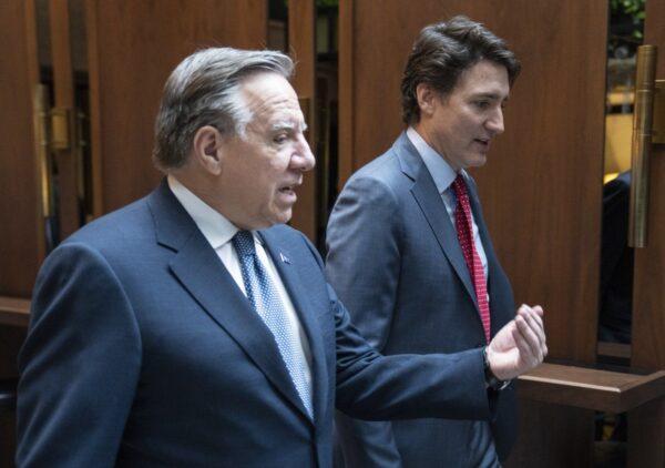 Prime Minister Justin Trudeau and Quebec Premier François Legault chat while walking to a meeting in Montreal, on Dec. 20, 2022. (The Canadian Press/Paul Chiasson)