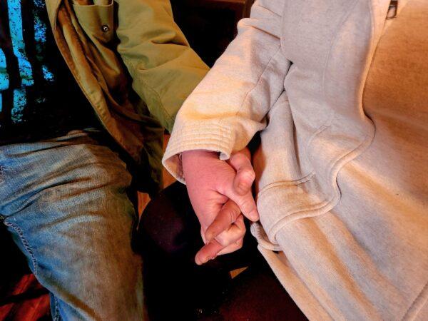 Rick Northrop and Juanita Hendrix hold hands at Operation: Transition Outside The Wire in Williams, Ariz., on Jan. 16, 2023. (Allan Stein/The Epoch Times)
