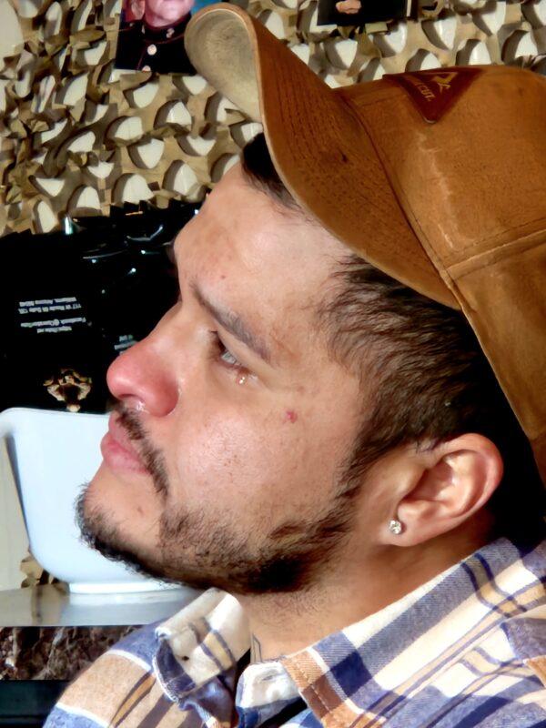 U.S. Army veteran Romel Armendariz of Williams, Ariz., reacts when hearing about other veterans suffering from post-traumatic stress disorder on Jan. 16, 2023. (Allan Stein/The Epoch Times)